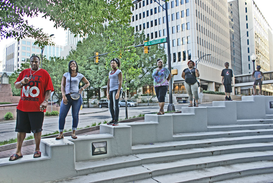 a family pose for a photo in Uptown Charlotte