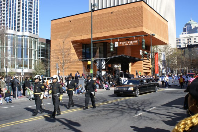 The MLK parade in Uptown Charlotte with the modern art museum in the background.