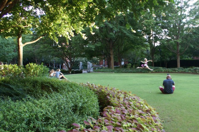 Running and jumping on the Green in Uptown Charlotte