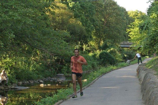 Jogger on the Little Sugar Creek greeway near Uptown Charlotte.