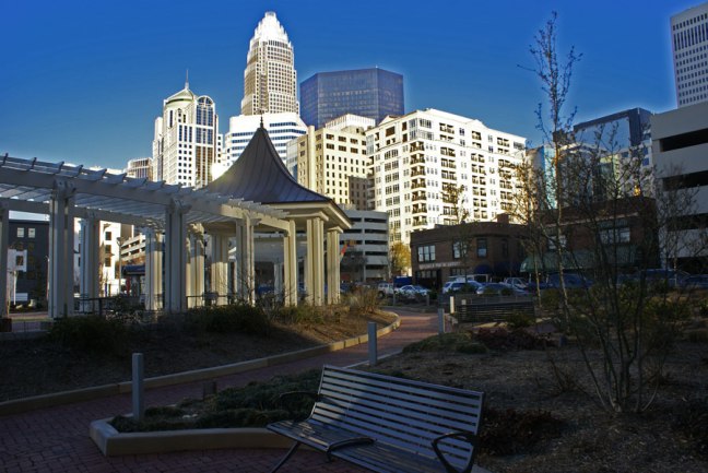 The Charlotte skyline lit in bright sunlight.