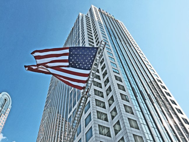 A really big American Flag hanging over the finish line at a foot race in Uptown Charlotte
